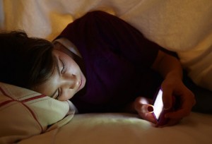 getty_rm_photo_of_teen_girl_texting_in_bed