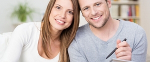 Happy young couple looking at a diagram